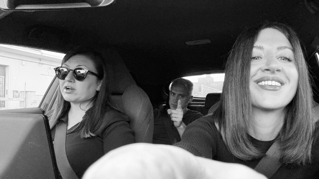 Two women smiling in a car