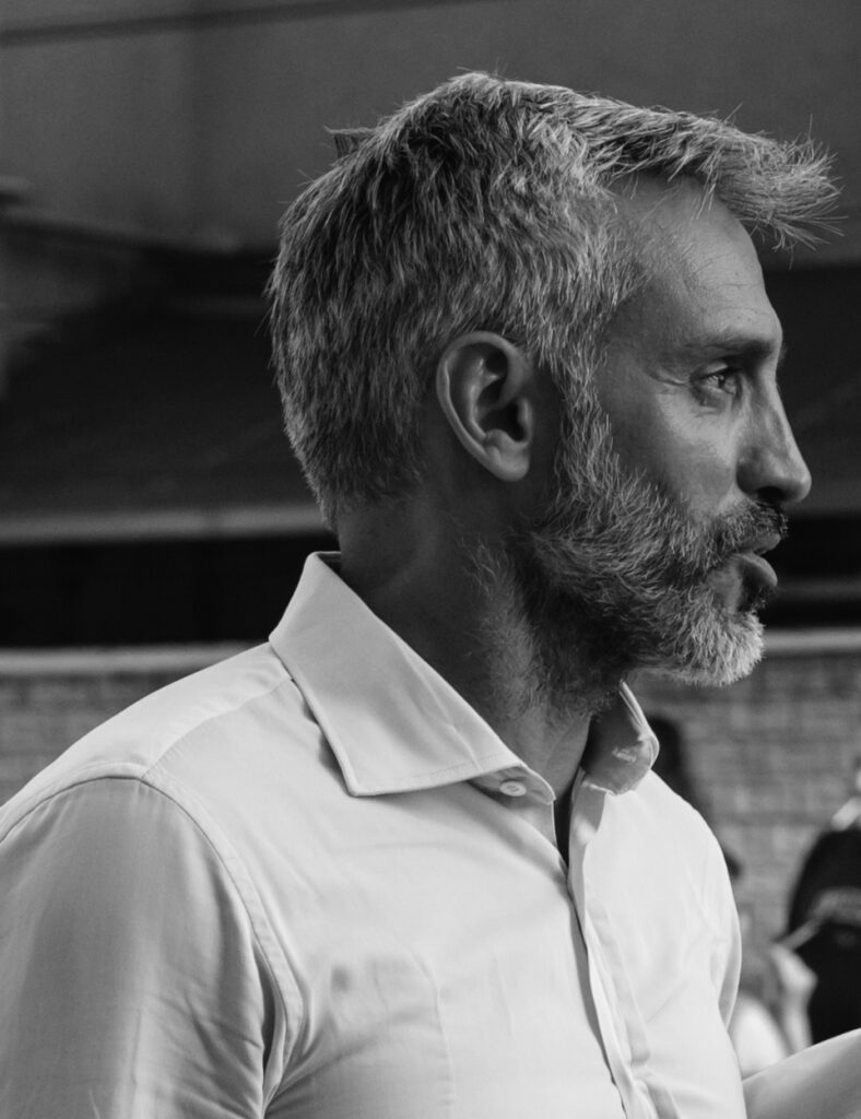 Black and white portrait of Antonio Menegatti in profile